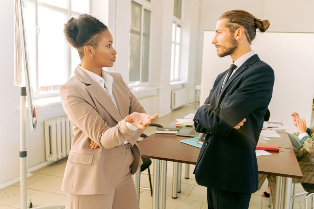 Business professionals in conversation during a meeting in a modern office environment.